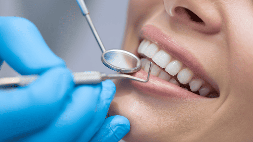 A dentist doing an Oral Examination on a female patient in Bayswater, WA